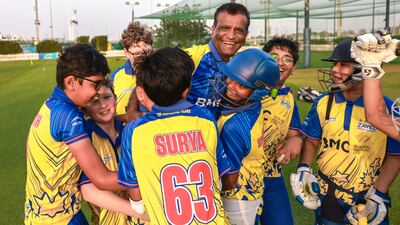 Cricket coach Sandeep Dhuri with youngsters at the academy that produced Abu Dhabi-born IPL player Yash Punja. Victor Besa / The National
