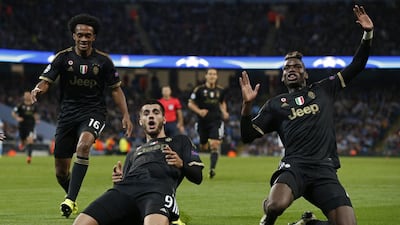 Juventus' Alvaro Morata, centre, celebrates with Paul Pogba, right, after scoring the second goal against Manchester City on Tuesday night. Reuters / Phil Noble