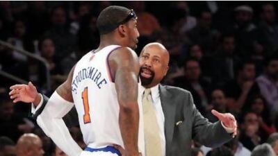 New York Knicks head coach Mike Woodson, right, talks to Amare Stoudemire during the first half of their game against the Philadelphia 76ers on Sunday. The Knicks won, 99-93. Mary Altaffer / AP Photo