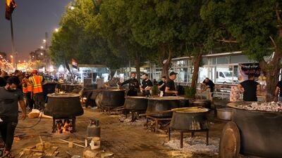 Food is prepared for Shiite Muslims on the ninth day of Muharram, outside the golden-domed shrine of Imam Moussa Al Kadhim in Baghdad, Iraq, Friday, July 28, 2023. AP