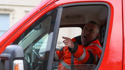 A van driver argues with protesters