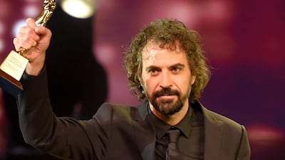 Uruguayan director Alvaro Brechner holds the golden pyramid award for Best Director