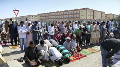 Worshippers pray outside a packed mosque in the Mussaffah area of Abu Dhabi. Satish Kumar for The National