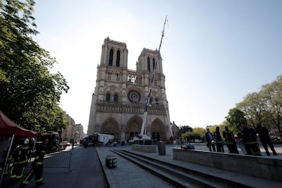 A crane works on a facade at the Notre-Dame Cathedral, days after a massive fire devastated large parts of the gothic structure in Paris. EPA