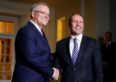 Scott Morrison shakes hands with Josh Frydenberg, right, who he appointed as Australia's new treasurer. Reuters