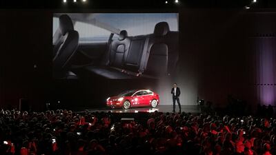 Tesla's chief executive Elon Musk introduces one of the first Model 3 cars off the Fremont factory's production line in California. Alexandria Sage / Reuters