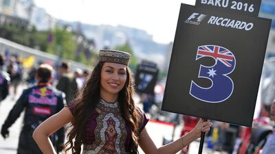 A grid girl holds a sign with the number of Red Bull Racing’s Australian driver Daniel Ricciardo. Andrej Isakovic / AFP