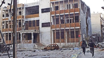 Residents run fearing snipers in Homs on February 22. Yazan Homsy / Reuters