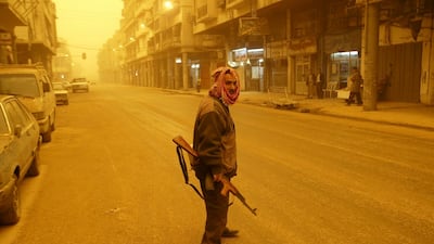 A militiaman patrols the streets of Baghdad, Iraq during a sandstorm March 26, 2003. AP