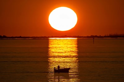 The sun sets at Grand Port Maritime de Marseille-Fos, off the coast of southern France. AFP