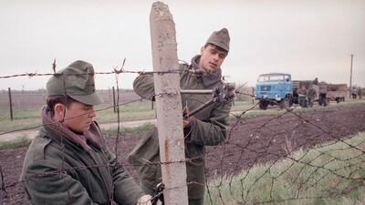 Hungarian border guards cut a hole into the "Iron Curtain," opening its border with Austria and the west near Hegyeshalom, some 50 kilometers east of Vienna. AP Photo