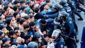 Migrants are held back by the Spanish Civil Guard before being transferred to a new pavilion in the north African exclave of Ceuta. EPA