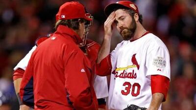 St. Louis Cardinals relief pitcher Jason Motte, right, reacts as manager Tony La Russa takes him from the game in the ninth inning of play against the Texas Rangers in Game 2 of the World Series.