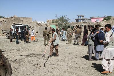 Afghan security forces inspect the site of a car bomb attack in Ghazni province, central Afghanistan, Sunday, July 7, 2019. AP
