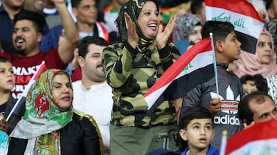 Iraqi fans cheer on their team during the international friendly football match between Iraq and Saudi Arabia at the Basra Sports city stadium. Local businesses are feeling the benefit after Fifa lifted a ban on the country hosting internationals. Haidar Mohammed Ali / AFP