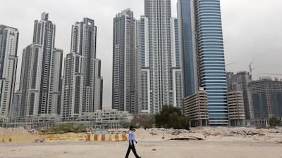 The Executive Towers, left, and other high-rises in Business Bay look out over the Burj Khalifa, Dubai Fountain and Old Town, but unfinished roads make access difficult for cars and pedestrians.