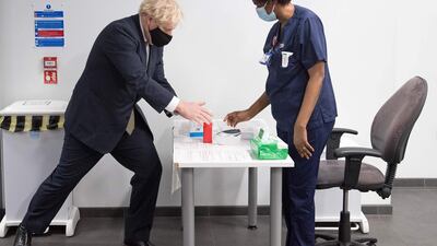 Boris Johnson uses hand sanitiser during a visit to Chase Farm Hospital in north London. AFP