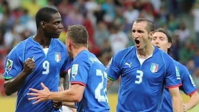 The temperamental Mario Balotelli, left, has settled down nicely with his Italian teammates during the tournament. Antonio Calanni / AP Photo