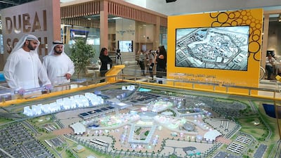 Visitors look at the model of the Expo 2020 site at the Cityscape Global. Satish Kumar / The National