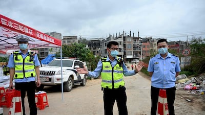 Policemen guard a checkpoint at Langnan village, in Wuzhou, near where Flight MU5375 crashed. AFP