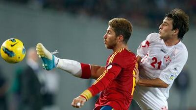 Sergio Ramos battles for the ball with Nika Dzalamidze during Spain's World Cup 2014 qualifying match against Georgia in Tblisi