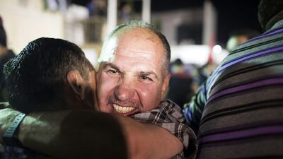 RAMALLAH, WEST BANK - AUGUST 14: A Palestinian prisoner released from an Israeli jail hugs his supporters in the Mikatah compound on August 14, 2013 in Ramallah, West Bank. Israel announced that 26 Palestinian prisoners will be released, 15 to Gaza and 11 sent to West Bank, as part of Israeli-Palestinian negotiations. (Photo by Ilia Yefimovich/Getty Images) *** Local Caption *** 176475865.jpg