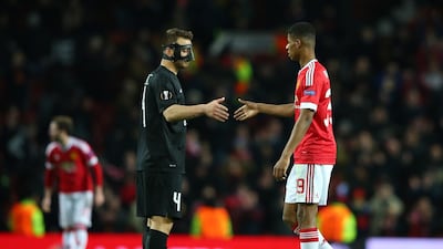 Marcus Rashford shakes hands with Nikolay Bodurov of Midtjylland after the match
