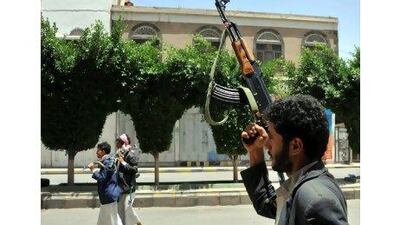 Armed tribesmen loyal to the tribe leader Sheikh Sadeq al Ahmar stang guard near the sheikh's house in Sana'a, Yemen yesterday. Yahya Arhab / EPA
