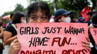 A Filipino activist holds a placard during a protest on International Women's Day, in Manila. Reuters