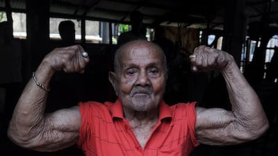 A file photo from March 16, 2012 shows Indian bodybuilder Manohar Aich at a gymnasium on the eve of his 100th birthday in Kolkata. India's first Mr Universe Aich died on June 5 at the age of 104 in Kolkata. Dibyangshu Sarkar/AFP