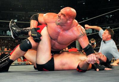 In this July 6, 1998, photo, wrestling heavyweight champion Bill Goldberg puts Scott Hall to the mat during a match in Atlanta. AP