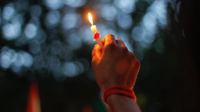July 16 2011: A man holds a candle during a rally against Wednesday's triple explosions in Mumbai. India's Prime Minister Manmohan Singh vowed on Thursday to bring to justice those behind triple bomb attacks on Mumbai, and police questioned members of hom???