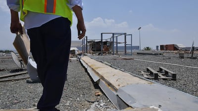 A worker fixing the damage at Abha airport. AFP