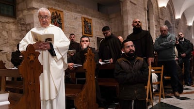 Members of the clergy attend the Christmas midnight Mass at the Church of the Nativity compound in Bethlehem, in the occupied West Bank. AFP