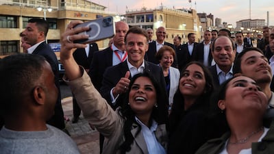 French President Emmanuel Macron and his Egyptian counterpart Abdel Fattah El Sisi pose for selfies with members of the public, near the Citadel of Qaitbay in Alexandria. AFP