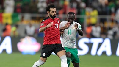 Egypt's Mohamed Salah and Sadio Mane of Senegal battle for the ball during the World Cup qualifier at the Diamniadio Olympic Stadium in Dakar on March 29, 2022. EPA