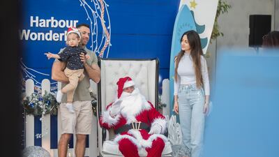 Visitors take photographs with Santa Claus.