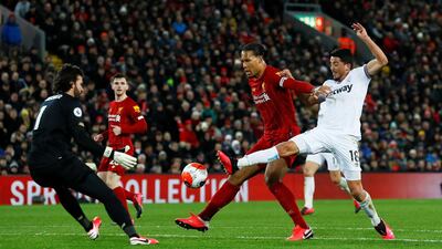 West Ham United's Pablo Fornals in action with Liverpool's Virgil van Dijk and Alisson. Reuters