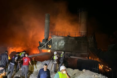 Firefighters tackle a blaze started by Israeli air strikes on a cement factory in the village of Ansar, in Nabatieh, southern Lebanon. AFP