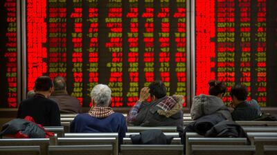 Chinese investors monitor stock prices at a brokerage house in Bejiing on Thursday. AP
