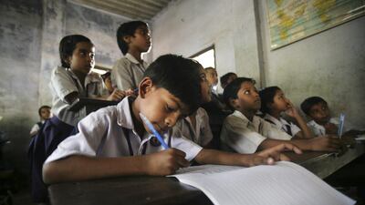 Students attend class at a school in Kolkata on Thursday, April 1, 2010, the day a law making primary education compulsory came into effect. Sucheta Das / AP Photo