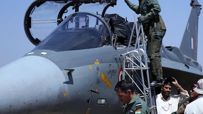 Chief of the Indian Army Bipin Rawat with an Indian Air Force Tejas fighter jet at Aero India 2019. EPA