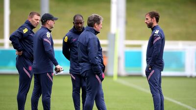 England manager Gareth Southgate, right, speaks to his coaching staff. PA