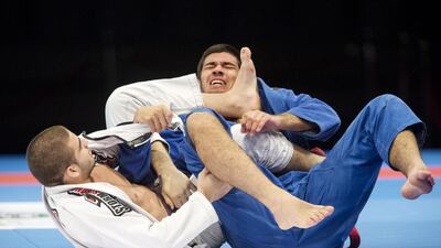 Gustavo Batista of Brazil, left, submits Pedro de Lima Elias during the purple belt open weight final during Abu Dhabi World Professional Jiu-Jitsu Championship at the IPIC Arena in Zayed Sports City in Abu Dhabi on April 23, 2016. Christopher Pike / The National