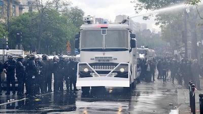 Police use water cannons to disperse crowds as thousands of people took to the streets of the French capital. Jeff J Mitchell/Getty Images