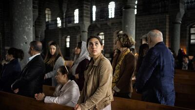 A young French-Armenian woman prays during Easter Sunday mass at Surp Giragos Ermeni Churche in Diyarbakır, Turkey. The church, which had fallen into ruin after the 1915 Armenian Genocide, was recently renovated and Armenians, many of them children and grandchildren of those who had been forced to flee, came from all around the world to celebrate Easter at their ancestors’ church. Scout Tufankjian