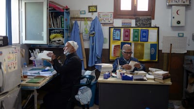 Libyan volunteers repair copies of the Quran during Ramadan in Tripoli. Reuters