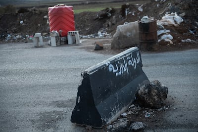 A barrier at an army checkpoint into Sweida, with the words 'Druze State' written on it. Hasan Belal for The National
