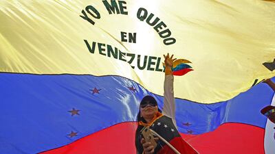 A woman holds a Venezuelan flag as she takes part in the "Venezuela Aid Live" concert. AFP