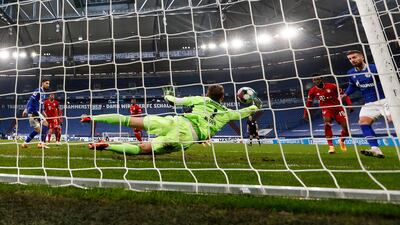 Bayern goalkeeper Manuel Neuer saves from Schalke's Mathew Hoppe. AP